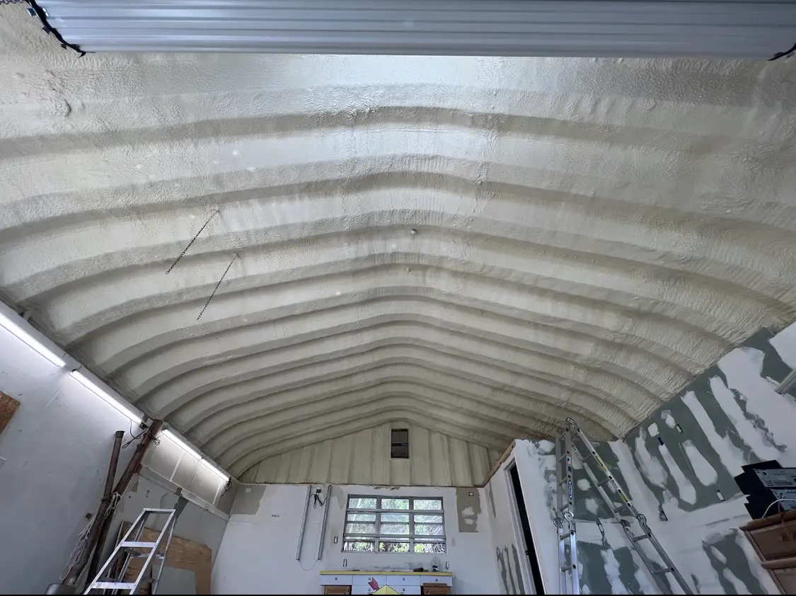 Spray polyurethane foam applied to the underside of a metal roof deck in Downey